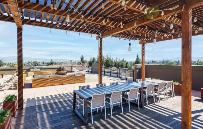 A wooden patio with a table and chairs.