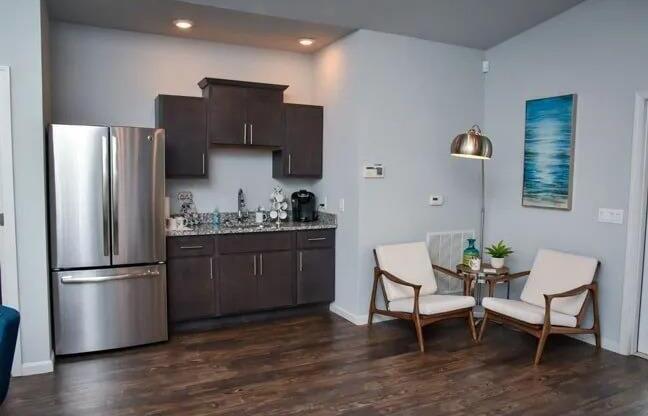 a kitchen with a stainless steel refrigerator and a table