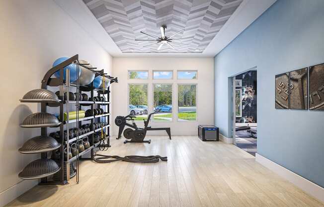 a workout room with a gym chair and a ceiling fan
