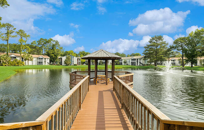 Gazebo at the end of a wooden dock overlooking a pond with a fountain at Vue at Baymeadows Apartments in Jacksonville, Florida