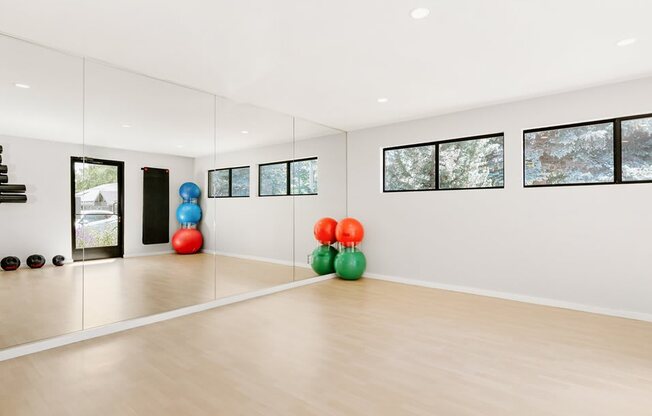 the living room has a mirrored wall and a dance floor with colorful spheres