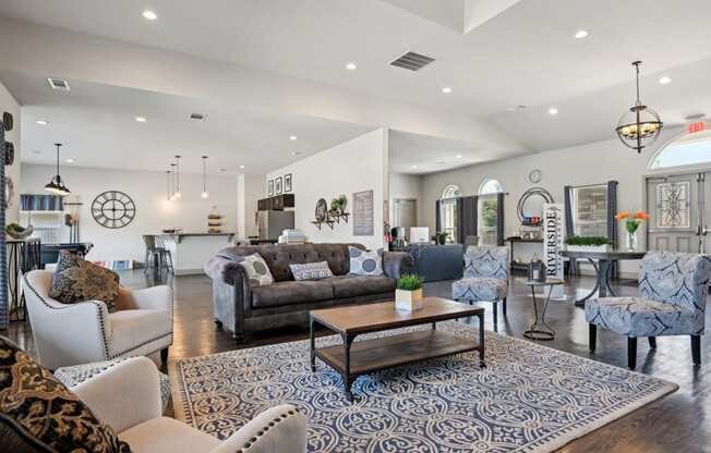 a living room with couches and chairs and a table