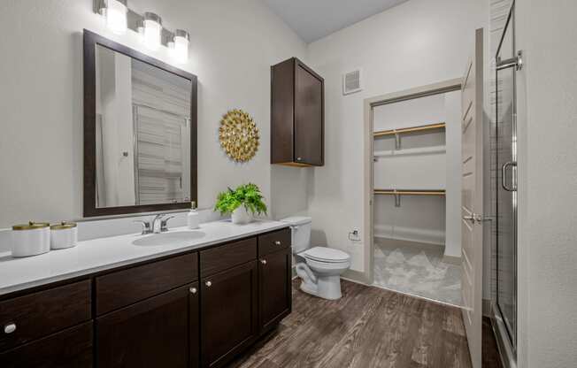 a bathroom with a shower and a sink and a toilet