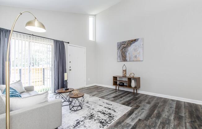 a living room filled with furniture and a large window