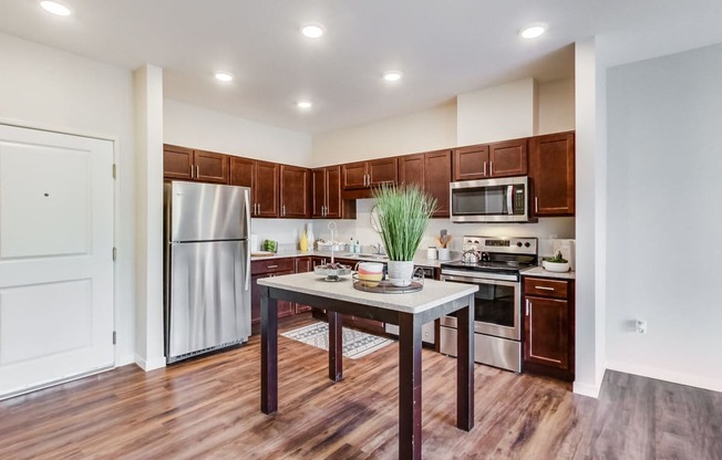 a kitchen with wooden cabinets and stainless steel appliances