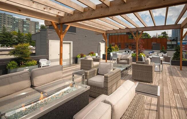 a roof deck with couches and tables