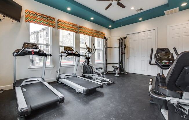 Fitness center with refreshing pool views at CLEAR Property Management , The Lookout at Comanche Hill, Texas