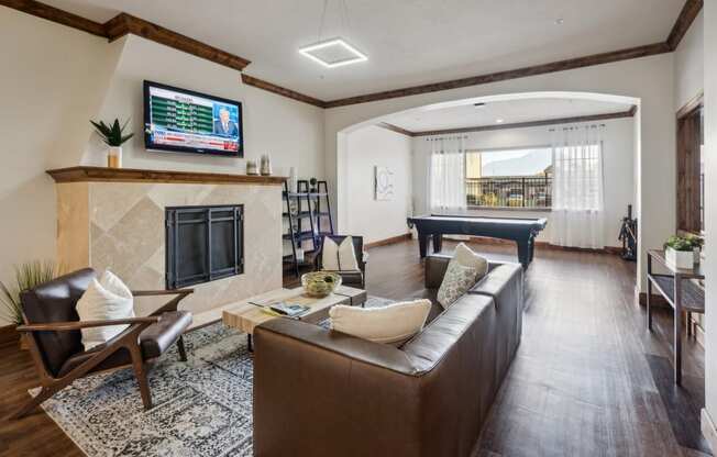 a living room with a leather couch and a television