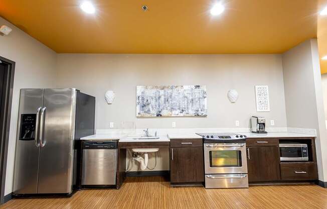a kitchen with stainless steel appliances and a sink and a refrigerator at Lowertown Commons Apartments, St. Paul