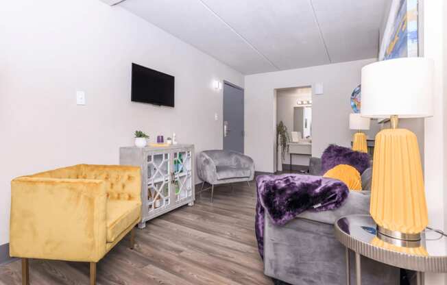A living room with a yellow sofa and a grey couch.
