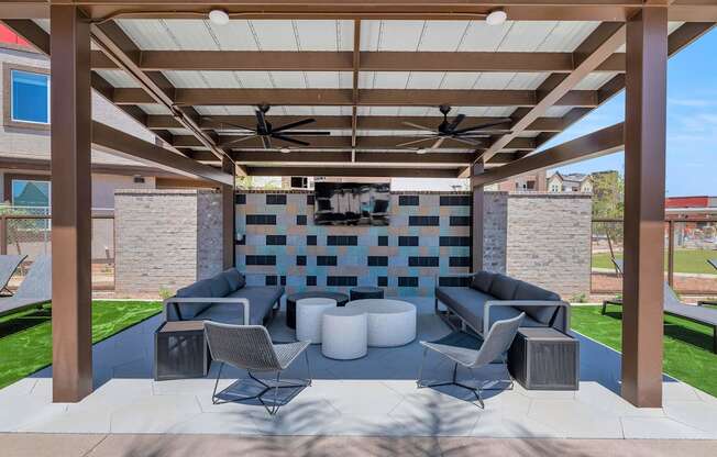 a covered patio with couches and chairs and a televisionat Weylyn Luxury Apartments, Laveen
