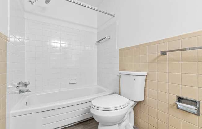 a bathroom with a tub and a toilet