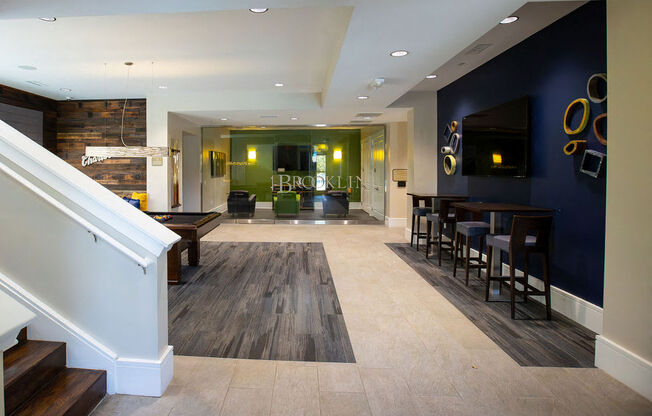 the lobby of a restaurant with a bar and stairs