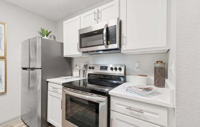 Model kitchen with stainless steel appliances at Mirage on Kernan Apartments in Jacksonville, FL
