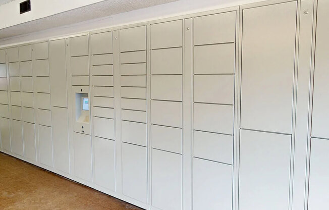 A row of white lockers in a room.