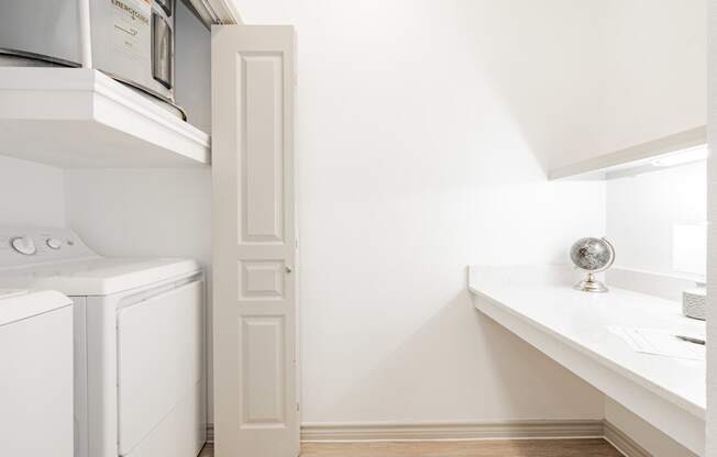 a laundry room with a washer and dryer and a window and a sink