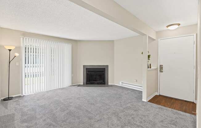 a living room with a fireplace and a doorway