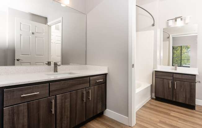 a bathroom with wooden cabinets and a sink and a mirror