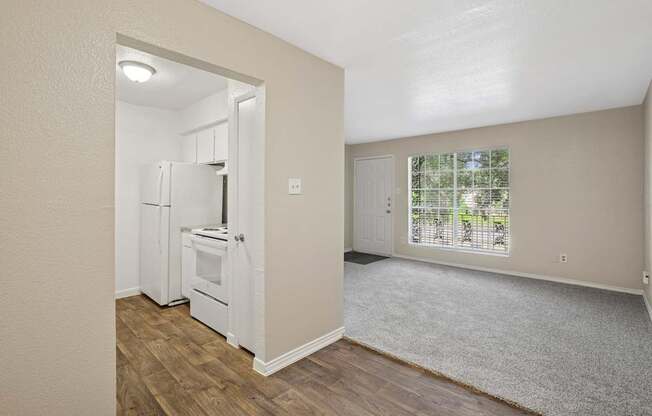 A kitchen with white appliances and a small dining area.