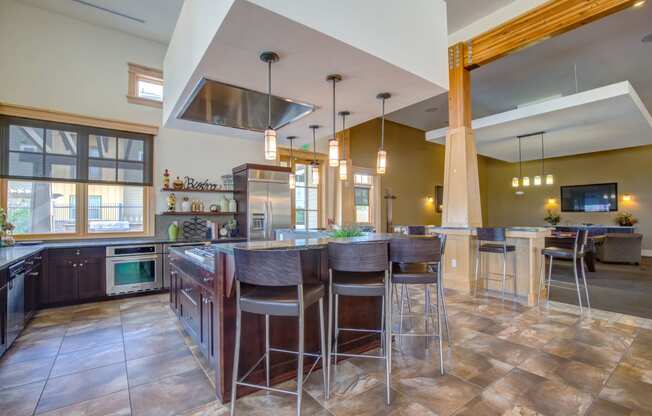 a large kitchen with a center island and bar stools
