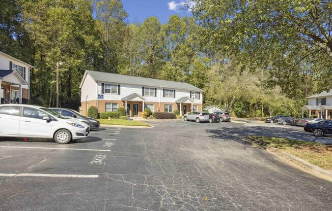 a parking lot with cars in front of a house