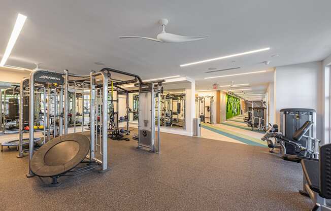 a gym with cardio equipment and weights in a building