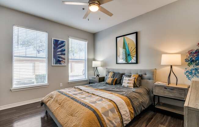 a bedroom with a large bed and a ceiling fan