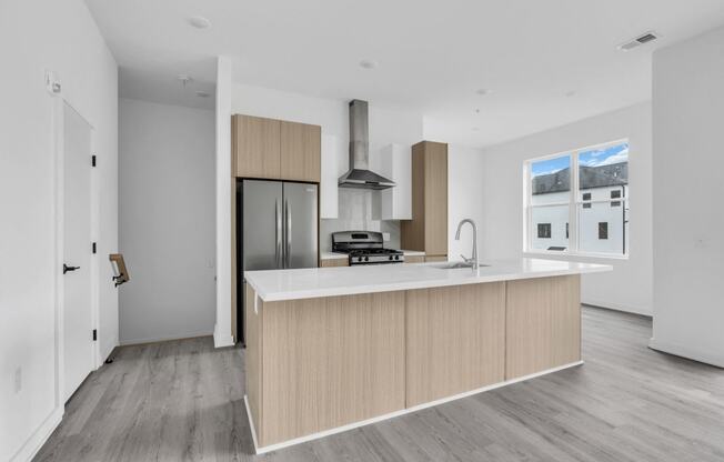 A modern kitchen with a wooden island and stainless steel appliances at The Franklin Marlboro Apartments, Marlboro, New Jersey