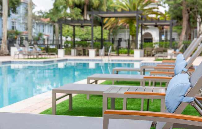 A poolside lounge area l at Floresta apartments in Jupiter, FL
