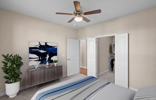 a bedroom with a large bed and a ceiling fan at The Dorset, Kansas City, 64112