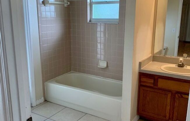 Available NOW! NEW FLOORS AND PAINT! Lovely 3/2 in Poinciana! HUGE fenced yard and NO CARPET!