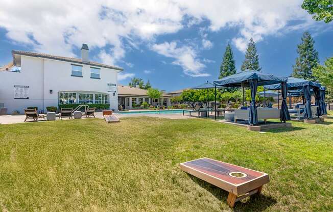Next to our pool deck, a grassy area with cornhole boards invites friendly outdoor fun with neighbors.
