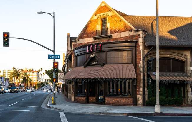 an old brick building with a brown awning on the corner of a street