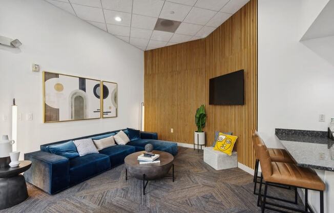 a living room with a blue couch and a table