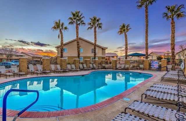 North Las Vegas, NV, Apartments for Rent - Portola Del Sol - Pool with Lounge Chairs and Palm Trees