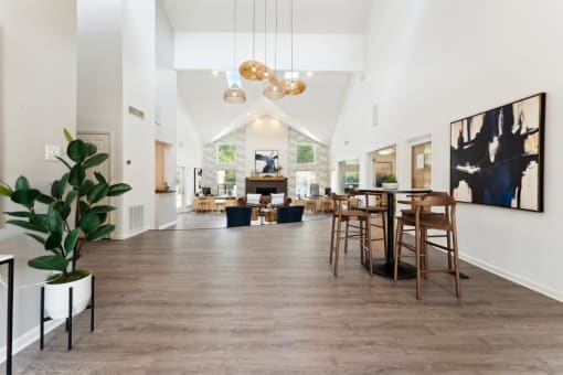 the gathering place at gardner village community room with white walls and wood flooring