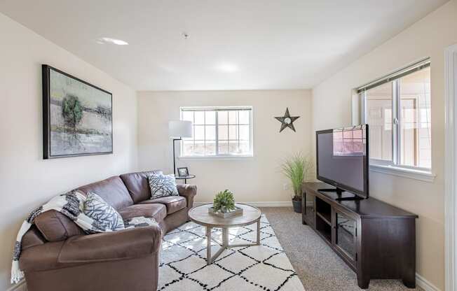 a living room with a couch and a tv  at Quail Springs, Washington, 99353