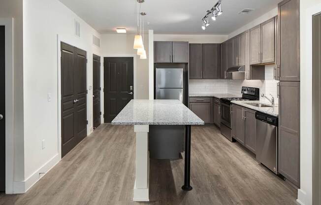 A kitchen with a table and chairs in the middle of it.