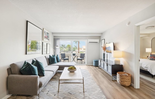 the living room of an apartment with a couch and a coffee table