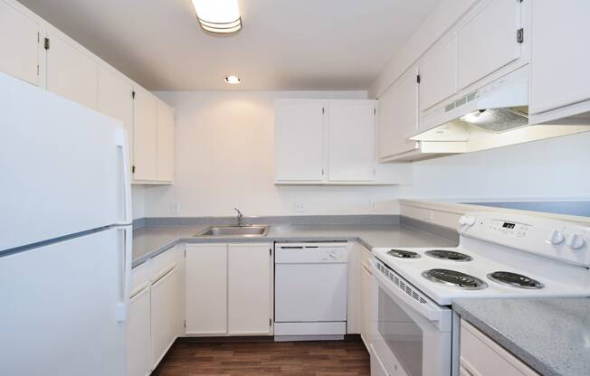 a kitchen with white cabinets and white appliances