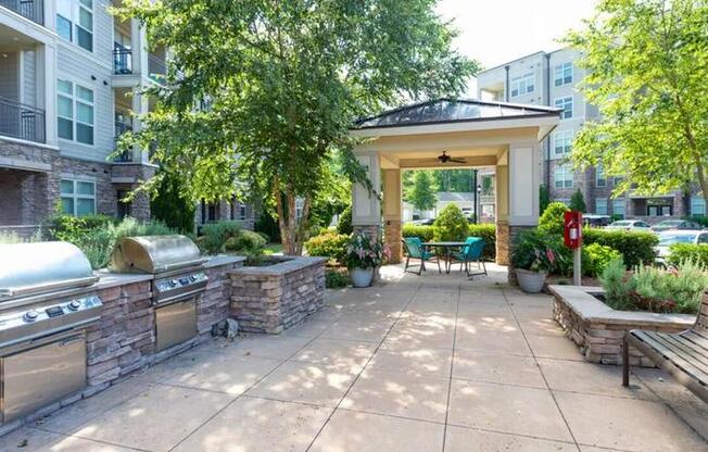 A patio area with a grill and seating area.
