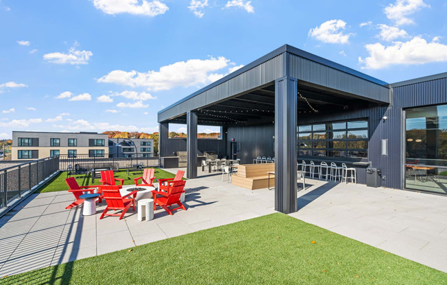 the outdoor patio of a building with red chairs and a patio