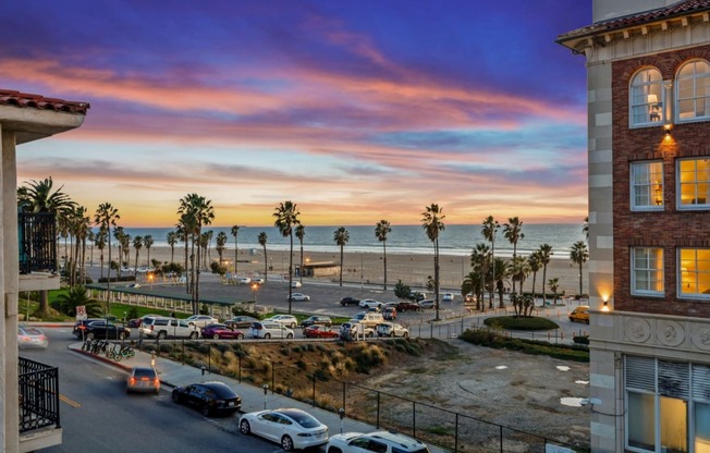 a view of the beach from a building at sunset