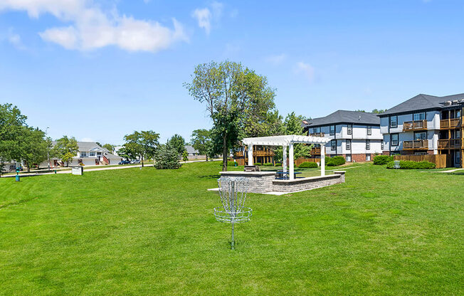 a large grassy area with a gazebo in the middle of it