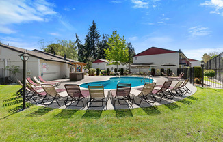 Cool Blue Swimming pool with Lounge Chairs and Grassy Area at Pinewood Square Apartment Homes, Lynnwood