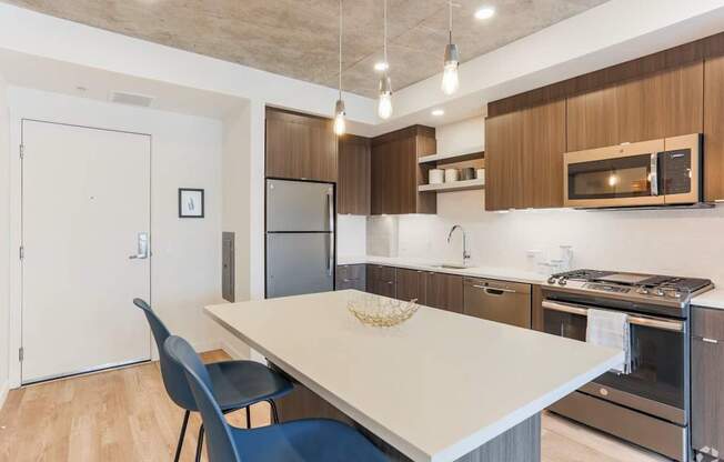 A kitchen with a table and chairs.