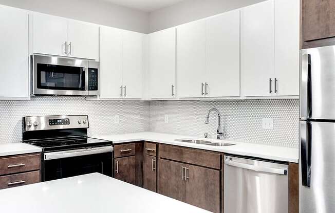 kitchen with brown and white shelves and stainless steel appliances