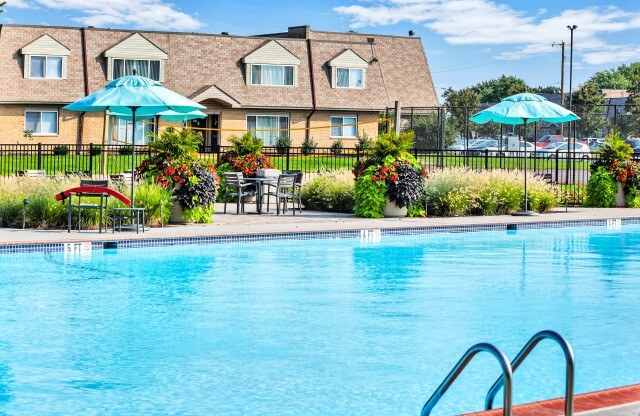 Outdoor swimming pool with sun deck at Franklin Commons apartments for rent in Bensalem, PA
