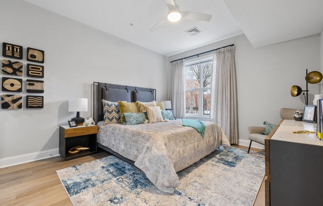 a bedroom with a large bed and a large window