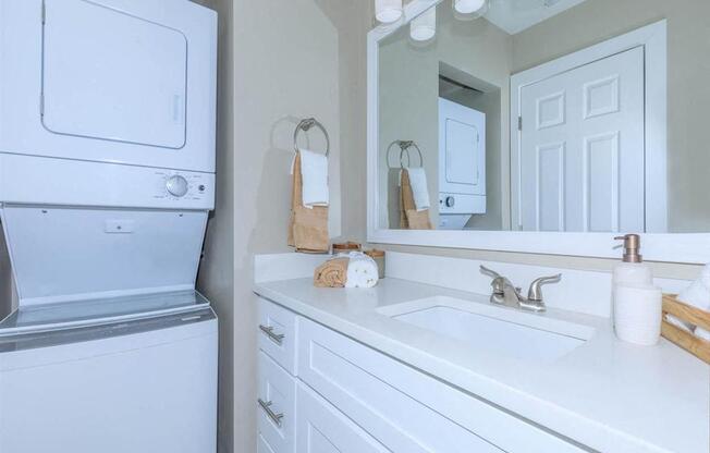 Model bathroom showcasing in home stacked washer and dryer